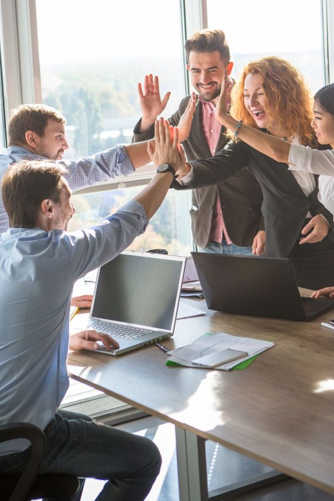 real estate team high fives